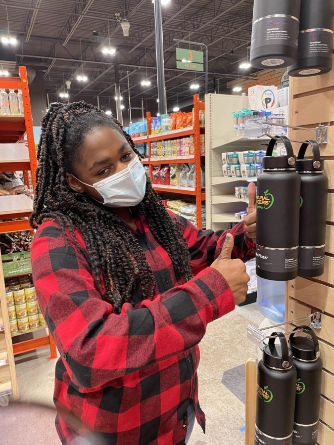 Queen Alahna posing next to Natural Grocers own Hydroflask