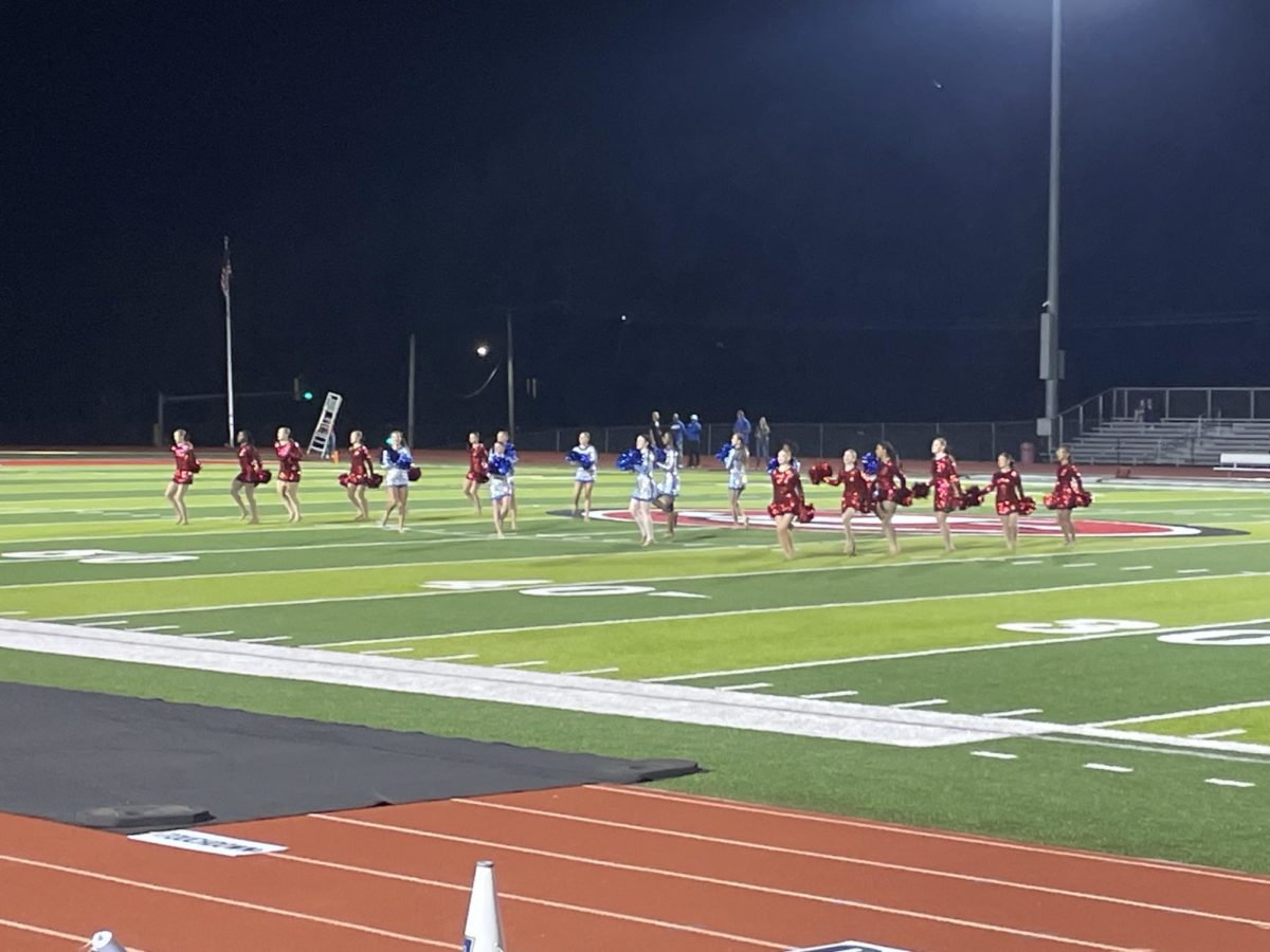 JCHS & CCHS cheer team performing at halftime.